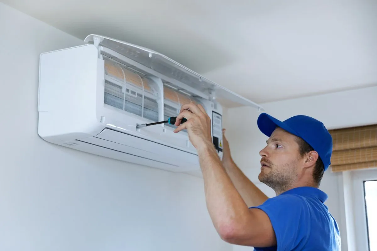 Air condition technician installing air conditioner on the wall at home in Albuquerque NM