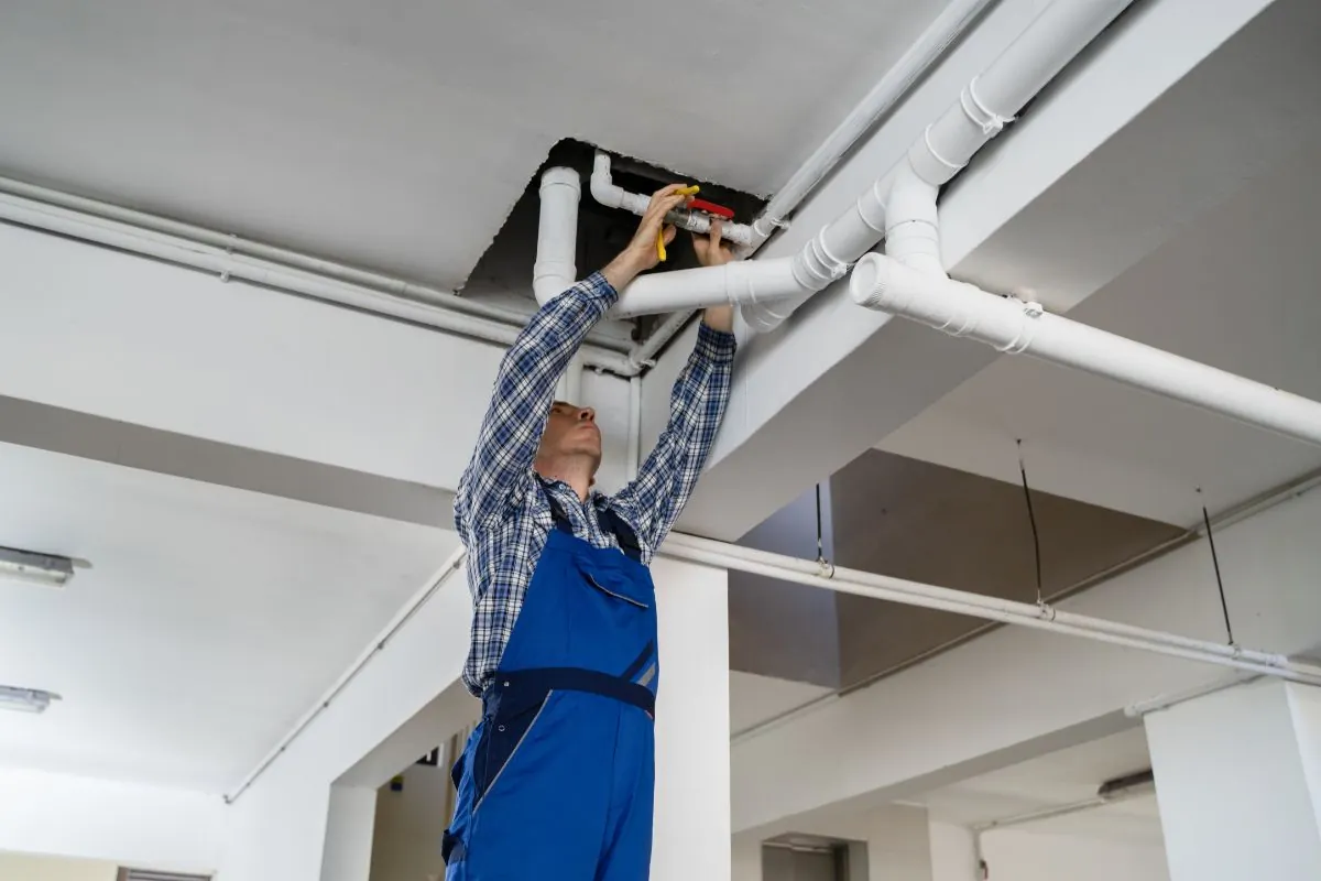 plumber repairing water pipe ceiling in ALbuquerque NM