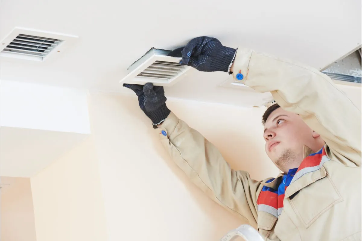 technician working on ventilation cleaning service