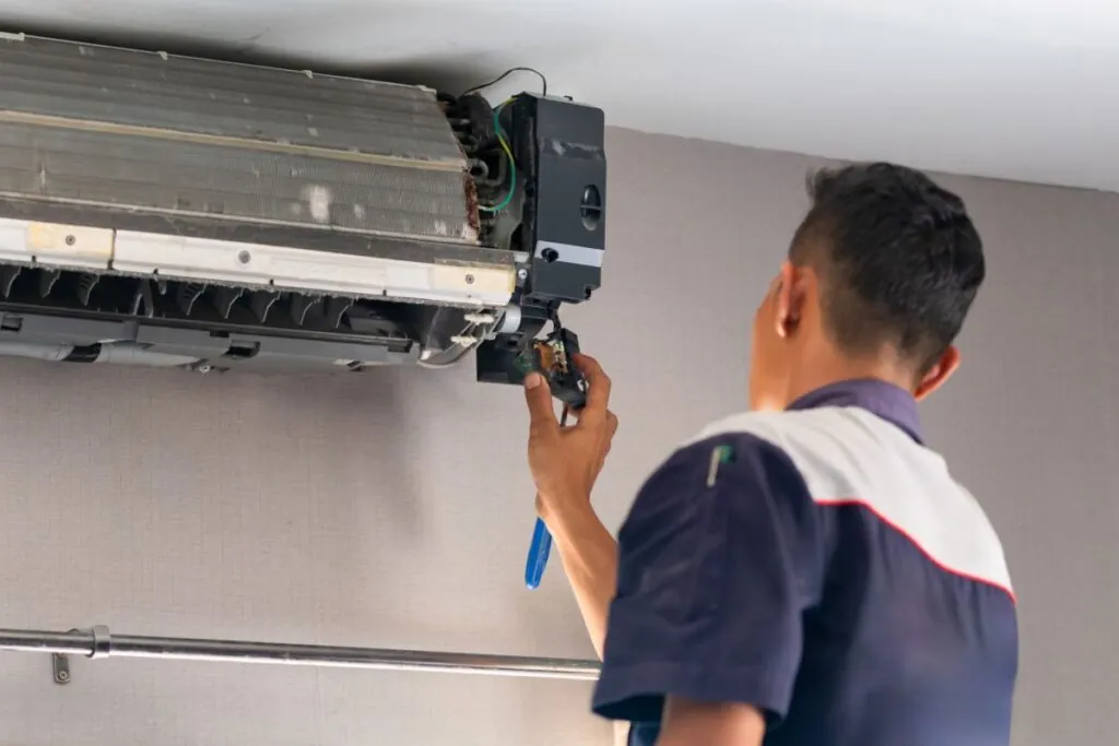 air conditioning repair, repairman checking air condition