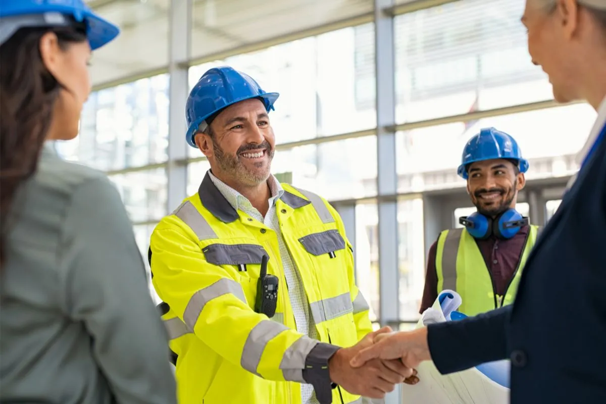 male contractor shaking hands with client